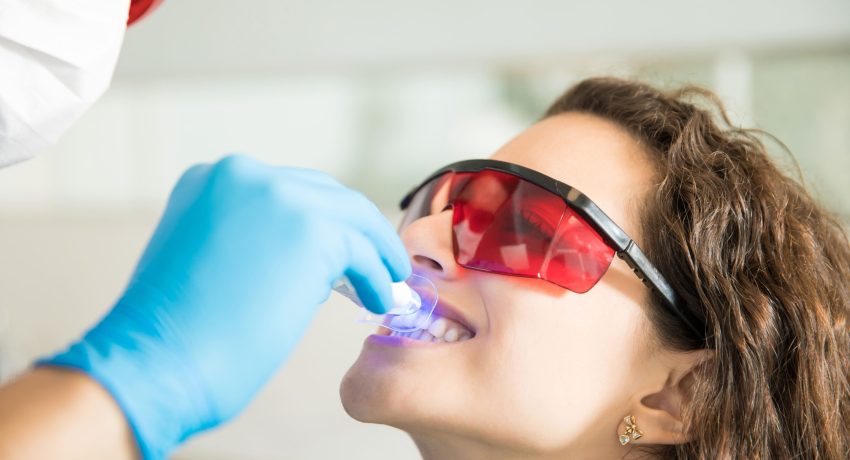 closeup-young-woman-having-her-teeth-whitened-with-ultraviolet-light-dental-clinic (2) (1)
