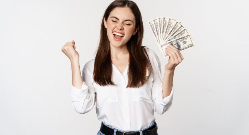 joyful-woman-dancing-with-money-smiling-pleased-winning-prize-standing-white-background(1)