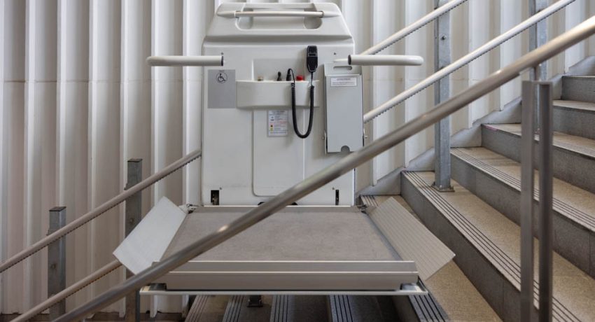 a stair lift for the disabled, wheel chair lift for stairs. Mechanical chair lift taking disabled or aged people up and down stairs.